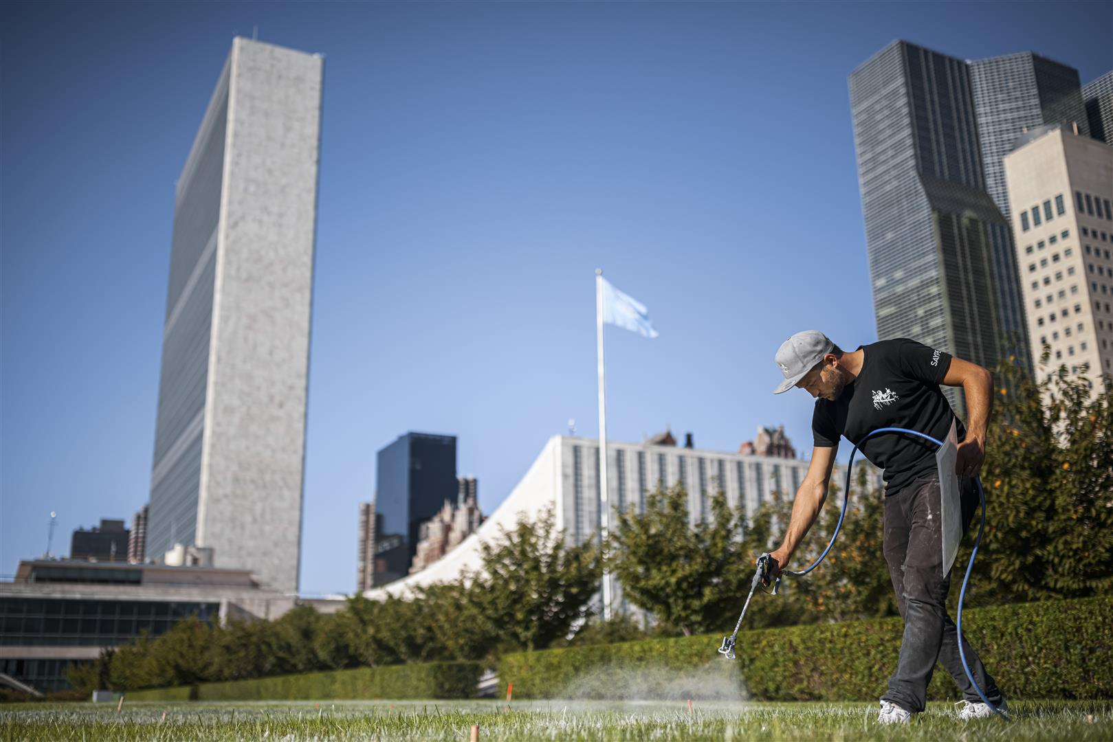 Saype at work on the North Lawn. Photo credit: Valentin Flauraud for Saype