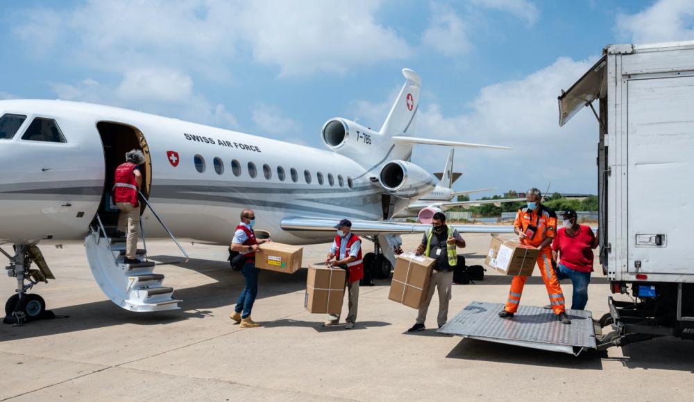 A Swiss humanitarian aid worker prepares to depart for an emergency mission